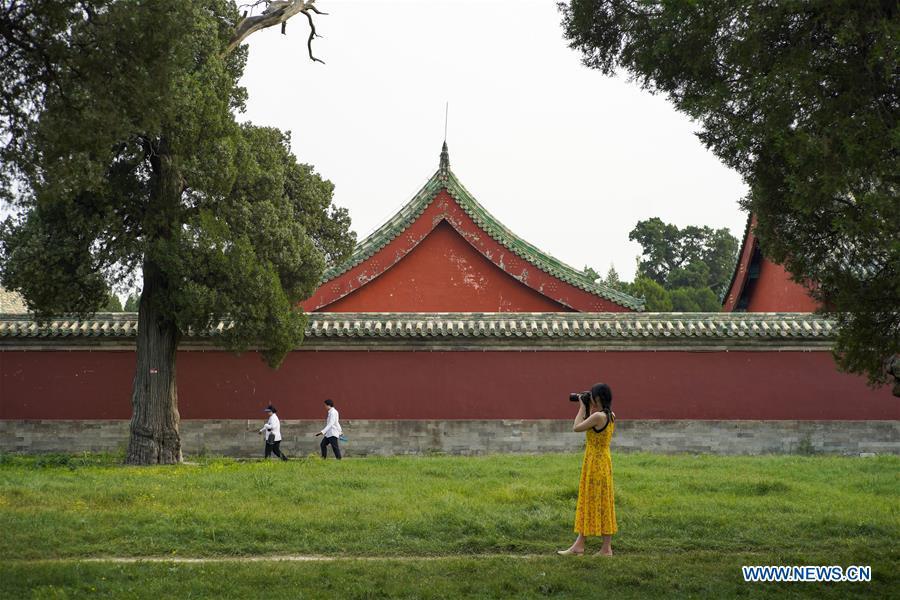Feng Ganyu takes pictures at the Temple of Heaven in Beijing, capital of China, May 11, 2019. A photographic exhibition themed \