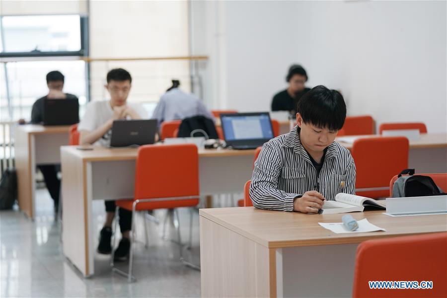 Ratjirot Aekkawat studies at a classroom of the Peking University in Beijing, capital of China, May 12, 2019. Ratjirot Aekkawat is of mixed blood from China and Thailand. He came to study in China as a junior student and now he is a postgraduate student of the Peking University. He always talks about his experience in China with relatives and friends. He has witnessed the development of China in recent years, during which the environment and local governments\' working efficiencies have been greatly improved. Chinese and Thai cultures are influenced with each other. Many Thai people celebrate the Spring Festival every year and lots of Chinese go to Thailand for tourism. The photo of the historical site of Ayutthaya Dynasty taken by Ratjirot Aekkawat will be displayed in a photographic exhibition \