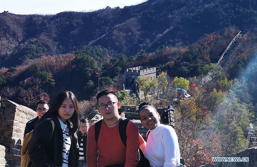 File photo taken in November of 2018 shows Sangay Tenzin (2nd R) posing for a photo with friends on the Great Wall in Beijing, capital of China. Sangay Tenzin, a Bhutanese student of Beijing Language and Culture University, is one of the photographers whose work was accepted by an exhibition themed \