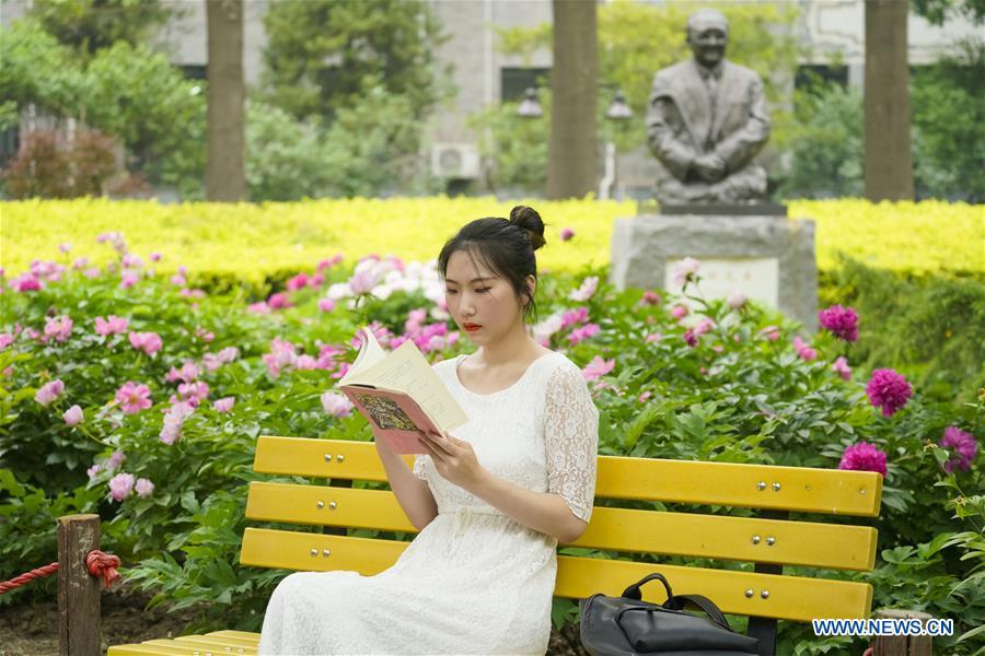 Feng Ganyu reads a book at Beijing Normal University in Beijing, capital of China, May 12, 2019. A photographic exhibition themed \