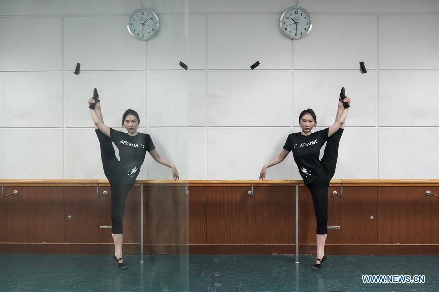 Feng Ganyu dances in a training room at Beijing Normal University in Beijing, capital of China, May 12, 2019. A photographic exhibition themed \