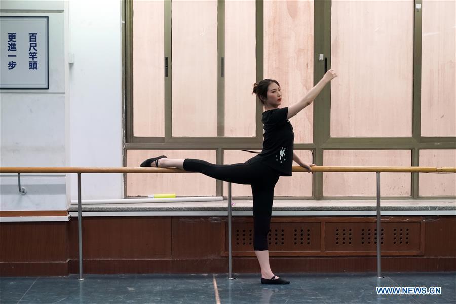 Feng Ganyu dances in a training room at Beijing Normal University in Beijing, capital of China, May 12, 2019. A photographic exhibition themed \