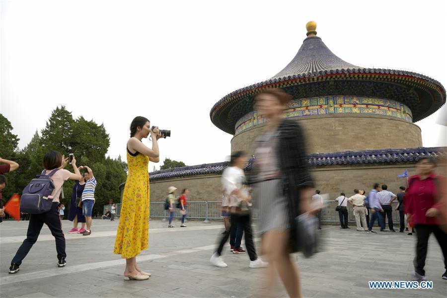 Feng Ganyu takes pictures at the Temple of Heaven in Beijing, capital of China, May 11, 2019. A photographic exhibition themed \
