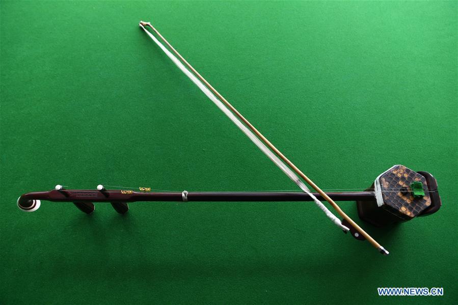 An Erhu is pictured in Lanzhou, northwest China\'s Gansu Province, May 13, 2019. Erhu, sometimes known as the Chinese violin or Chinese two-stringed fiddle, is a Chinese traditional two-stringed bowed musical instrument. It is used as a solo instrument as well as in small ensembles and large orchestras. Erhu, traced back to ancient Chinese Tang dynasty (618-907), is now used in both traditional and contemporary music arrangements, such as in pop, rock and jazz. The famous solo pieces include Er Quan Ying Yue (Two Springs Reflecting the Moon) by Abing and Sai Ma (Horse Race) by Huang Haihuai. (Xinhua/Fan Peishen)