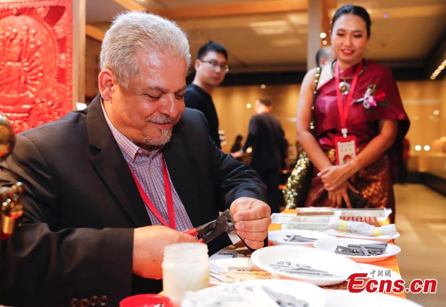 Photo taken on May 16, 2019 shows an exhibition of intangible cultural heritages from Asia at the National Library of China in Beijing as part of the ongoing Conference on Dialogue of Asian Civilizations. More than 60 craftsmen from 13 Asian countries and regions are displaying traditional works such as puppets from Sri Lanka, Persian carpets from Iran and costumes from the Philippines. (Photo: China News Service/Du Yang)