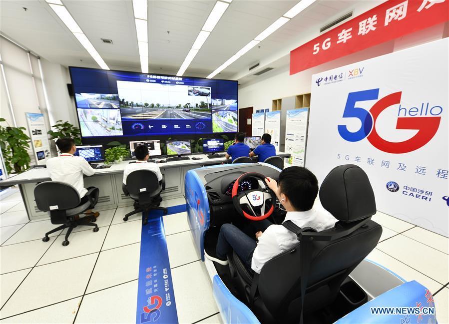A technician controls a car at a driving simulation cabin in a lab during a test run in Chongqing, southwest China, May 15, 2019. A remote-controlled car powered by the 5G network completed a test run on Wednesday in Chongqing. During the test run, a remote operator was able to control the car while watching the live feed of road conditions supported by the 5G network. (Xinhua/Liu Chan)