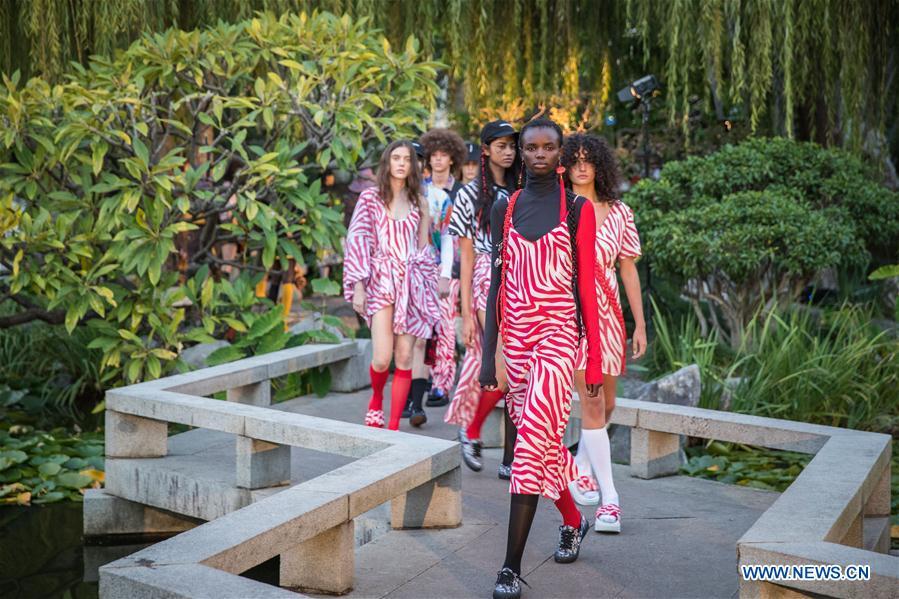 Models wearing creations by Double Rainbouu pose during Fashion Week Australia at the Chinese Garden of Friendship in Sydney, Australia, May 15, 2019. (Xinhua/Zhu Hongye)