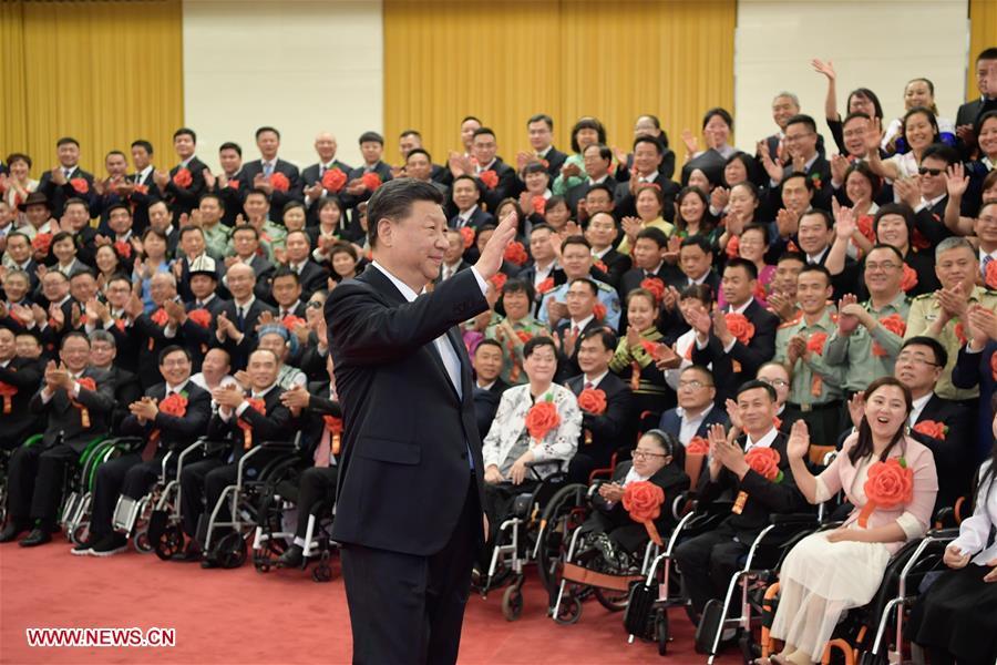 Chinese President Xi Jinping, also general secretary of the Communist Party of China (CPC) Central Committee and chairman of the Central Military Commission, meets with representatives attending a ceremony commending role models with disabilities and people who have made outstanding contributions in helping the disabled, at the Great Hall of the People in Beijing, capital of China, May 16, 2019. Premier Li Keqiang and Wang Huning, a member of the Secretariat of the CPC Central Committee, both members of the Standing Committee of the Political Bureau of the CPC Central Committee, also met with the representatives. (Xinhua/Li Xueren)
