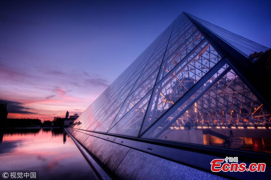 View of the glass pyramid, designed by Chinese-born U.S. Architect I.M. Pei, which is the entrance of the Louvre Museum in Paris. World-renowned architect Ieoh Ming Pei, commonly known as I.M. Pei, has died at age 102. Pei was born in Guangzhou, China, and raised in Hong Kong and Shanghai, before moving to the United States in 1935. He won a wide variety of prizes and awards in the field of architecture. (Photo/VCG)