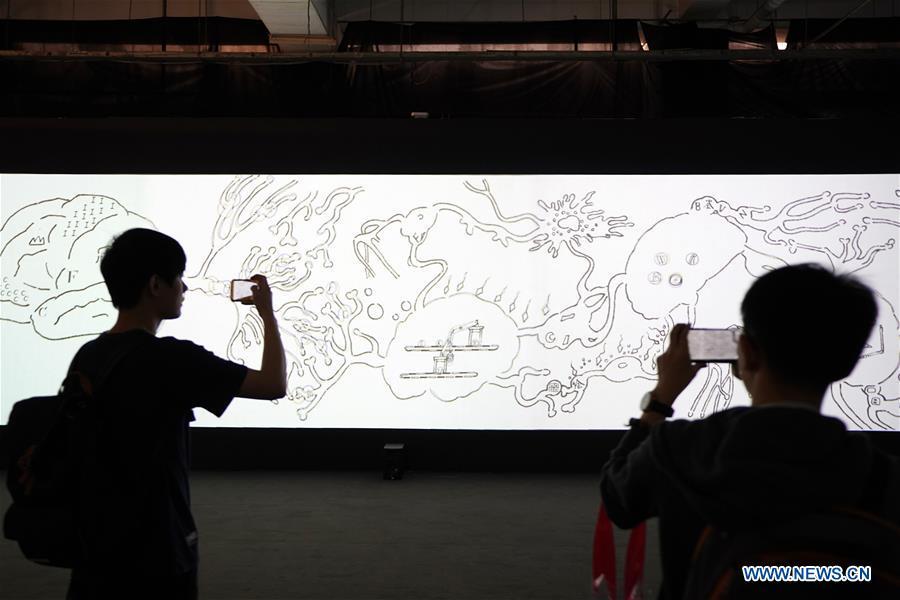 Visitors take pictures of an art work during the Asian Digital Art Exhibition held in Beijing, capital of China, May 16, 2019. The exhibition, part of the cultural activities of the Conference on Dialogue of Asian Civilizations, kicked off on Thursday. Works of 30 artists from 12 countries and regions are on show during the exhibition. (Xinhua/Ju Huanzong)