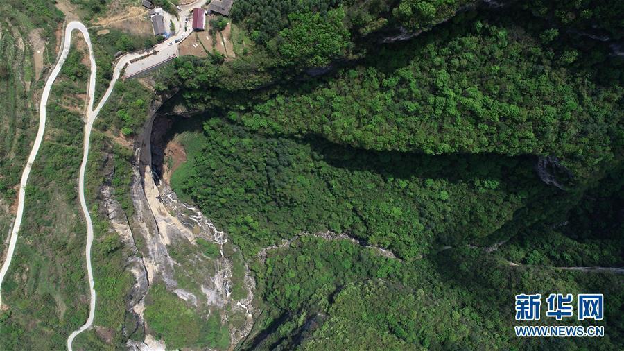 An aerial photo shows a waterfall in Didonghe Tiankeng, a giant karst sinkhole at Huoshizi Village of Ningqiang County in Hanzhong, northwest China\'s Shaanxi Province. With a maximum depth of 340 meters, the Didonghe Tiankeng is the largest in Chanjiayan Tiankeng Group in Ningqiang County. (Photo/Xinhua)