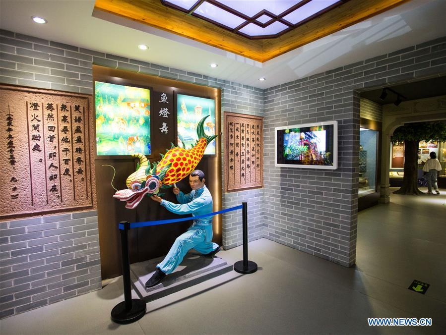 A visitor views exhibits at a museum themed Shatoujiao fish lantern dance in Yantian District of Shenzhen, south China\'s Guangdong Province, May 18, 2019. The Chung Ying Street (Chung Ying means China and Britain), linking Shenzhen of Guangdong Province and Hong Kong in south China, has once again set sail in the development of the Guangdong-Hong Kong-Macao Greater Bay Area and embarked on a new journey towards high-quality development. (Xinhua/Meng Chenguang)