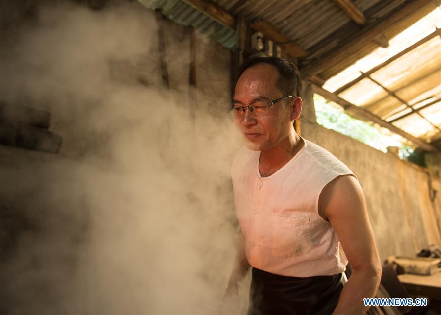 Zheng Guorong refines billet at Guyue Sword Studio in Longquan, east China\'s Zhejiang Province, May 21, 2019. For centuries, Longquan has been famed for its sword making industry. Zheng Guorong, 55, an intangible cultural heritage inheritor in Longquan Sword making, has been making sword for more than 30 years. Zheng regards sword as a symbol of spirit and devotes all to his career with awe. In his studio, the whole process of making a single sword takes two to three months, with steps including forming an idea, designing the sketch, preparing material and the final making and assembling. After setting up his studio, Zheng has trained more than 20 apprentices, who have all become sword smiths of great reputation. The old sword smith insists that Longquan sword, with a history of more than 2,500 years, deserves to be carried on in our time, both materially and spiritually. (Xinhua/Weng Xinyang)