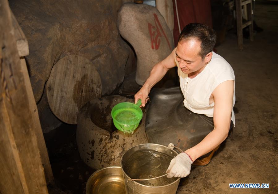 Zheng Guorong works at Guyue Sword Studio in Longquan, east China\'s Zhejiang Province, May 21, 2019. For centuries, Longquan has been famed for its sword making industry. Zheng Guorong, 55, an intangible cultural heritage inheritor in Longquan Sword making, has been making sword for more than 30 years. Zheng regards sword as a symbol of spirit and devotes all to his career with awe. In his studio, the whole process of making a single sword takes two to three months, with steps including forming an idea, designing the sketch, preparing material and the final making and assembling. After setting up his studio, Zheng has trained more than 20 apprentices, who have all become sword smiths of great reputation. The old sword smith insists that Longquan sword, with a history of more than 2,500 years, deserves to be carried on in our time, both materially and spiritually. (Xinhua/Weng Xinyang)