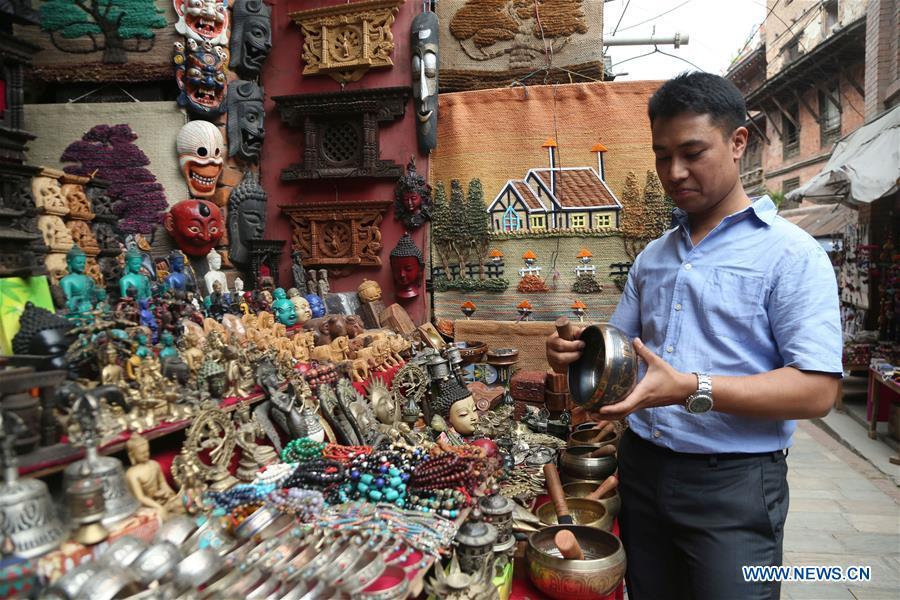 Binaya Hada buys gifts for his Chinese friends at a shop in Bhaktapur, Nepal on May 15, 2019. Binaya Hada is a 34-year-old Nepali young man, whose work was selected for a photographic exhibition on Asian civilization. Graduated from Beijing Language and Culture University of China, Binaya is now dedicated to learning Chinese culture and popularizing knowledge of Chinese language to local population. (Xinhua/Sunil Sharma)