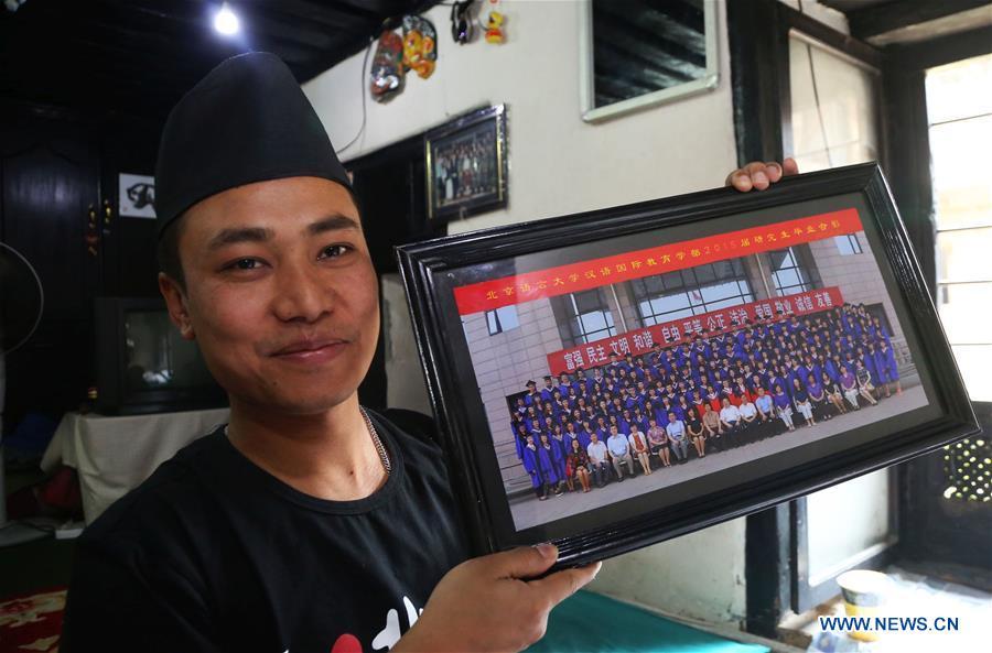 Binaya Hada shows his graduation photo of Beijing Language and Culture University at his home in Bhaktapur, Nepal on May 15, 2019. Binaya Hada is a 34-year-old Nepali young man, whose work was selected for a photographic exhibition on Asian civilization. Graduated from Beijing Language and Culture University of China, Binaya is now dedicated to learning Chinese culture and popularizing knowledge of Chinese language to local population. (Xinhua/Sunil Sharma)