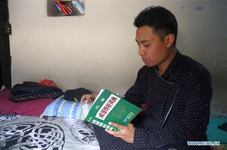 Binaya Hada reads a Chines book at his home in Bhaktapur, Nepal on May 15, 2019. Binaya Hada is a 34-year-old Nepali young man, whose work was selected for a photographic exhibition on Asian civilization. Graduated from Beijing Language and Culture University of China, Binaya is now dedicated to learning Chinese culture and popularizing knowledge of Chinese language to local population. (Xinhua/Sunil Sharma)