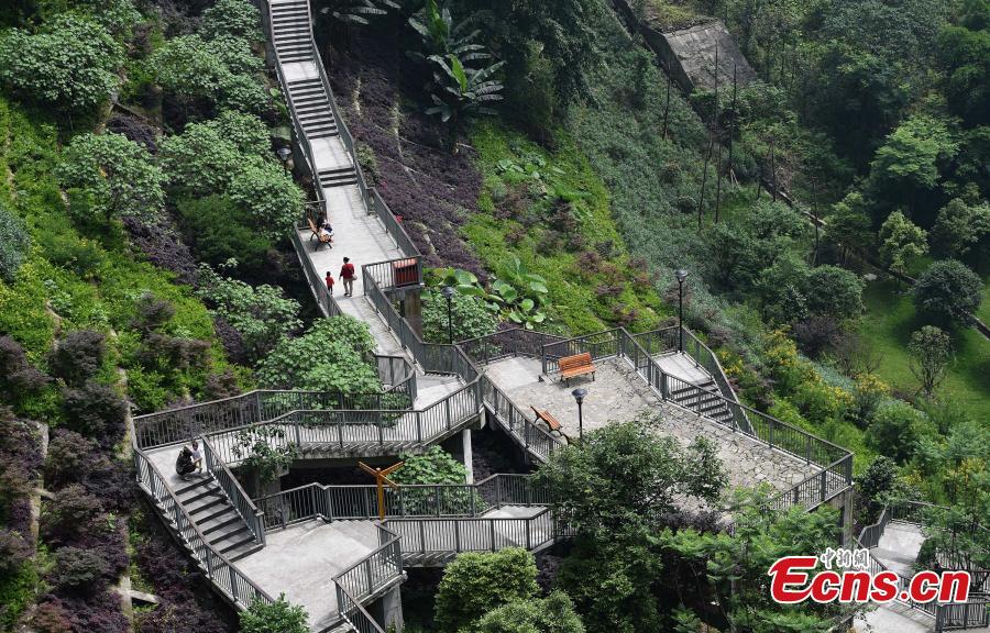 A view of a pathway built along a hilly slope leading to the entrance of a residential community in Yuzhong District, Southwest China’s Chongqing Municipality, May 22, 2019. The road is about one kilometre long, with a height of nearly 100 meters. Built on mountains, the city has been nicknamed a \