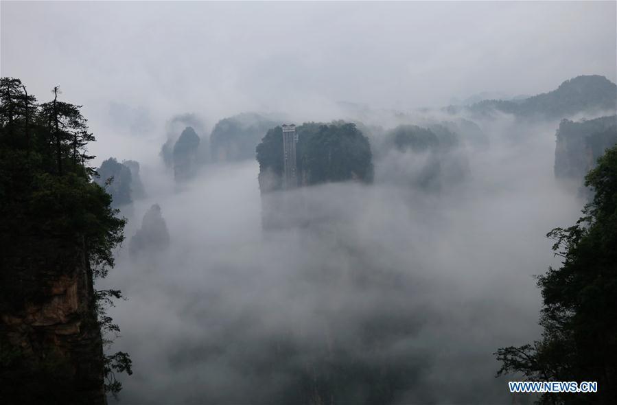 Aerial photo taken on May 25, 2019 shows the 326-meter-high Bailong Elevator, the world\'s highest outdoor elevator, shrouded by fog at the Wulingyuan Scenic Area in Zhangjiajie, central China\'s Hunan Province. (Xinhua/Wu Yongbing)