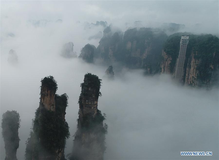Aerial photo taken on May 25, 2019 shows the 326-meter-high Bailong Elevator, the world\'s highest outdoor elevator, shrouded by fog at the Wulingyuan Scenic Area in Zhangjiajie, central China\'s Hunan Province. (Xinhua/Wu Yongbing)