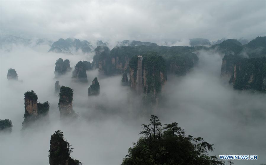 Aerial photo taken on May 25, 2019 shows the 326-meter-high Bailong Elevator, the world\'s highest outdoor elevator, shrouded by fog at the Wulingyuan Scenic Area in Zhangjiajie, central China\'s Hunan Province. (Xinhua/Wu Yongbing)