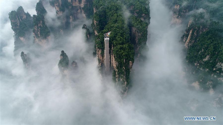 Aerial photo taken on May 25, 2019 shows the 326-meter-high Bailong Elevator, the world\'s highest outdoor elevator, shrouded by fog at the Wulingyuan Scenic Area in Zhangjiajie, central China\'s Hunan Province. (Xinhua/Wu Yongbing)