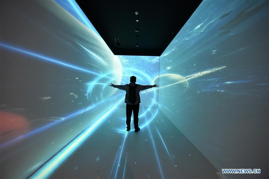 A visitor stands in a \