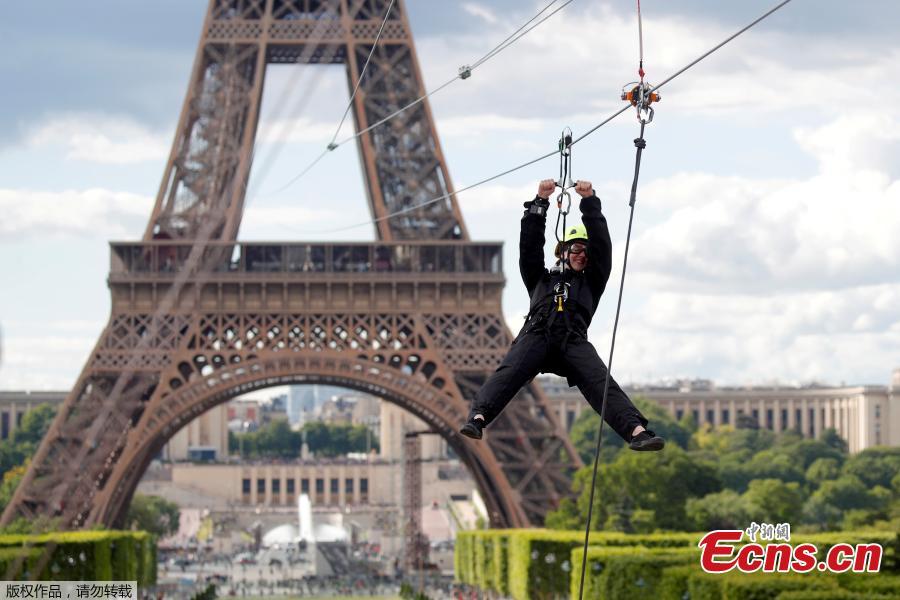 A participant rides a zip line from the second floor of the Eiffel Tower, 115 metres above the ground along an 800-metre long route, as part of the Smash Perrier free event operating until June 2 in Paris, France, May 28, 2019.(Photo/Agencies)