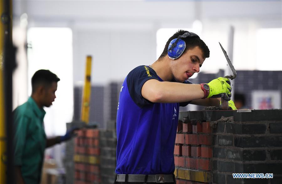 A contestant participates in the bricklaying competition during the Belt And Road International Skills Competition held in Chongqing International Expo Center in Chongqing, southwest China, May 29, 2019. (Xinhua/Wang Quanchao)