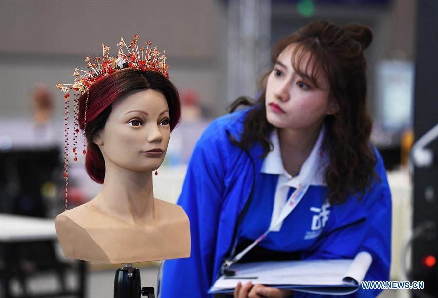 A contestant participates in the hairdressing competition during the Belt And Road International Skills Competition held in Chongqing International Expo Center in Chongqing, southwest China, May 29, 2019. (Xinhua/Wang Quanchao)
