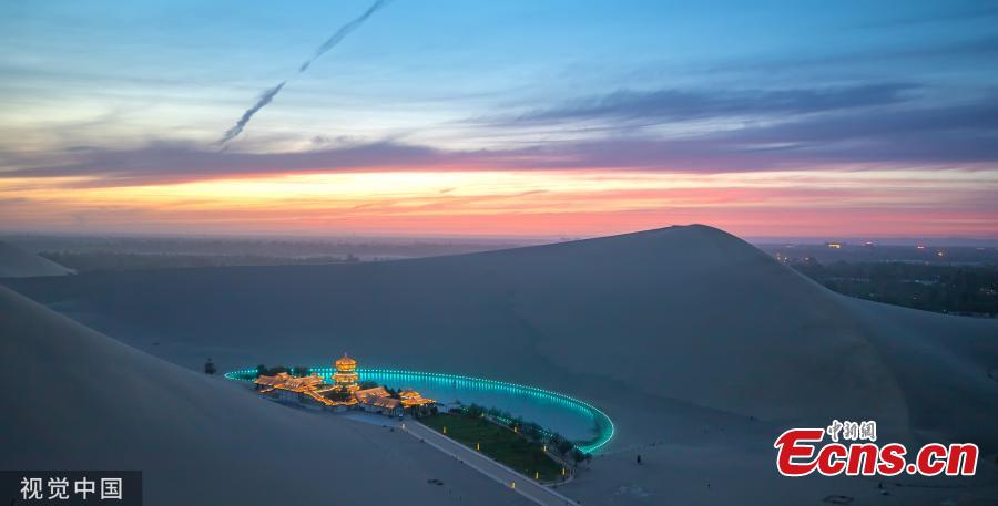 Dunhuang city in Northwest China\'s Gansu province, is brightened by stars when the nights falls in May, 2019. (Photo/VCG)
