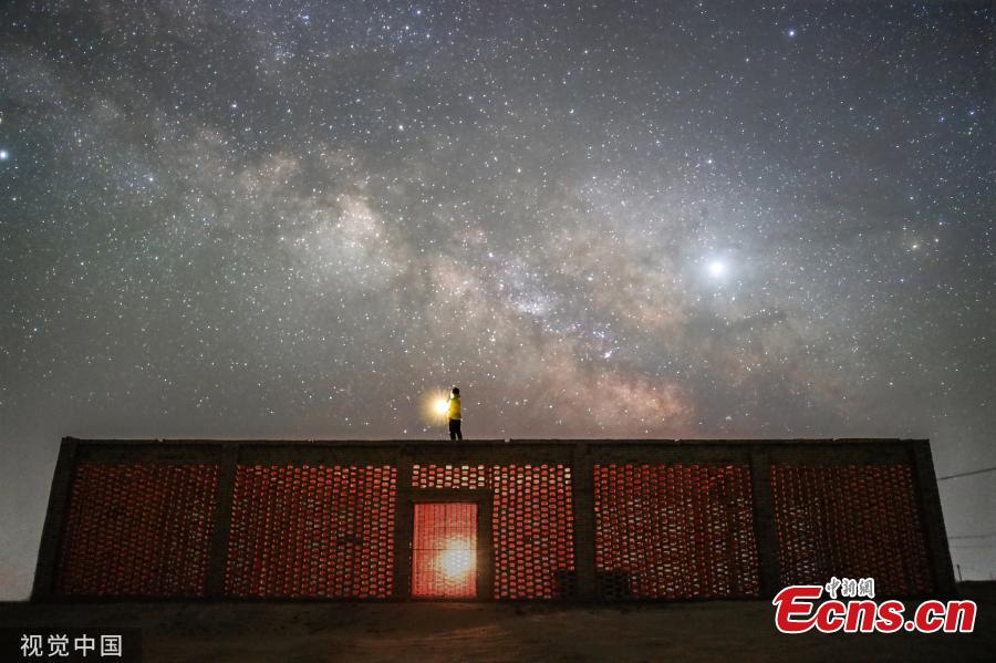 Dunhuang city in Northwest China\'s Gansu province, is brightened by stars when the nights falls in May, 2019. (Photo/VCG)