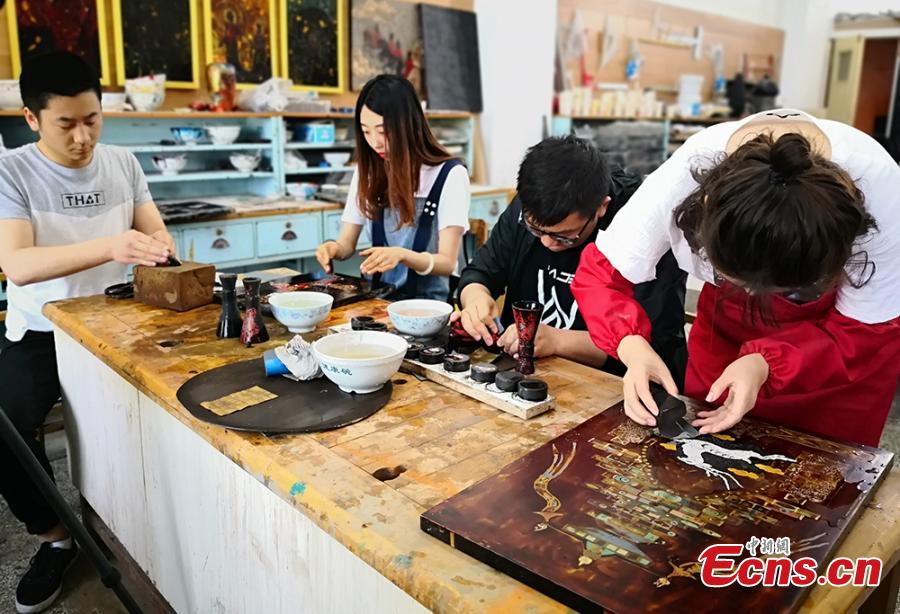 Students and teachers use traditional methods to make lacquerware at the Lanzhou Polytechnic College in Lanzhou City, Northwest China’s Gansu Province. The process of decorating a cup with layers of lacquer usually takes 20 days. Lacquerware refers to a variety of traditional crafts that have lacquer as their surface layer, sometimes with the addition of gold or silver sheets, eggshell, or other materials. (Photo: China News Service/Liu Yutao)