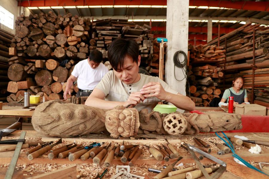 Craftsmen repair wooden components of ancient residences at a warehouse in Bengbu Ancient Residence Exhibition Park based in Bengbu, East China\'s Anhui province. （By Zhu Lixin/chinadaily.com.cn）