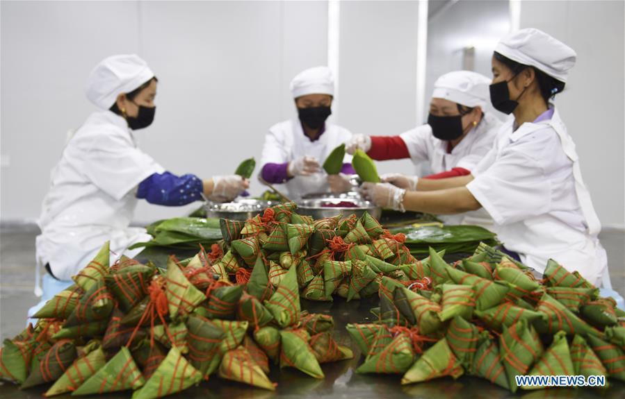 Workers make colorful Zongzi, pyramid-shaped dumplings made of glutinous rice wrapped in bamboo or reed leaves, at a factory in Taijiang County, southwest China\'s Guizhou Province, June 2, 2019. Different plant juices are used to color the glutinous rice when making the colorful Zongzi. Zongzi is a traditional food for the Dragon Boat Festival, which falls on June 7 this year. (Xinhua/Liu Kaifu)