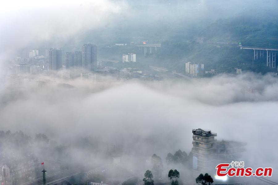 Fog shrouds buildings in the Wine Town, near the Yangtze River, in Fuling District, Chongqing Municipality, June 2, 2019. (Photo: China News Service/Shi Wei)