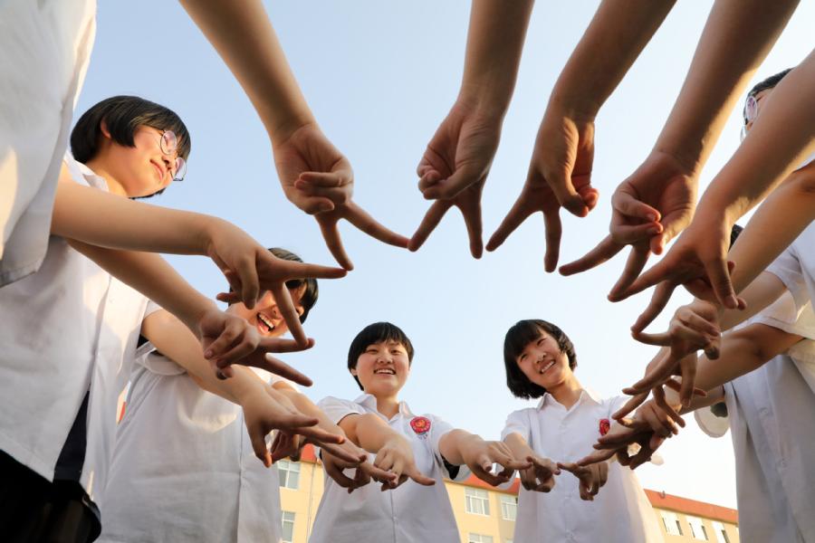 Seniors at a high school in Binzhou, East China\'s Shandong Province, make a V for victory sign to encourage each other ahead of the gaokao, China\'s national college entrance exam, on June 2, 2019. (Photo/Xinhua)
