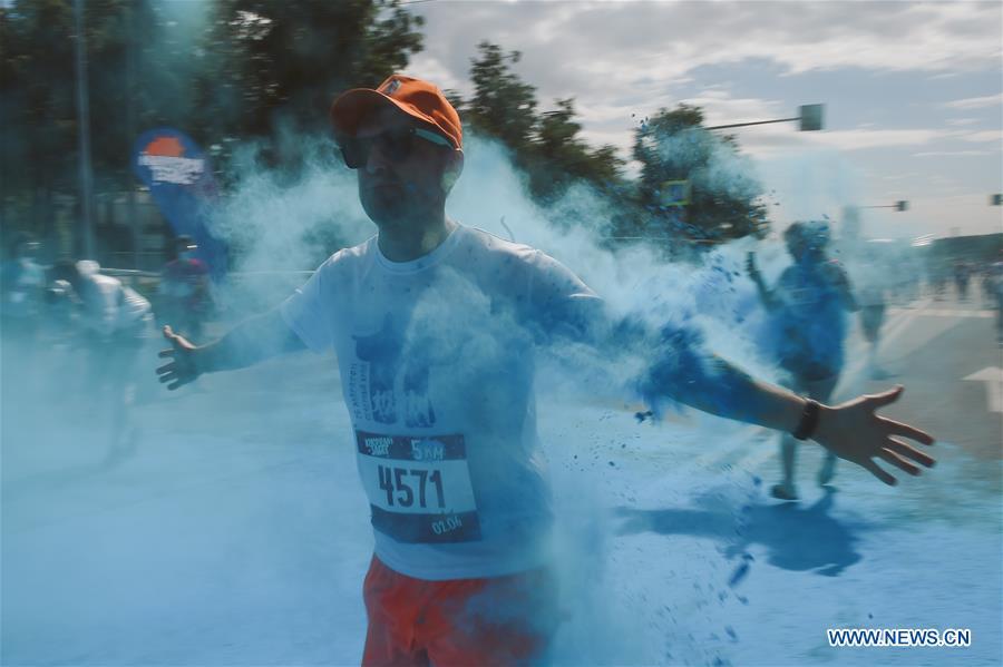 Participants run through colored powder during the annual color run in Moscow, Russia, June 2, 2019. (Xinhua/Evgeny Sinitsyn)