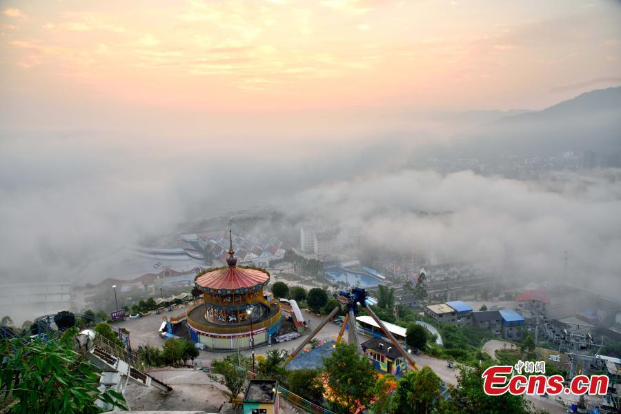 Fog shrouds buildings in the Wine Town, near the Yangtze River, in Fuling District, Chongqing Municipality, June 2, 2019. (Photo: China News Service/Shi Wei)