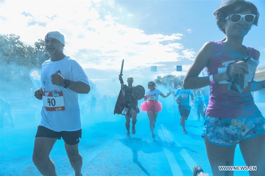 Participants run through colored powder during the annual color run in Moscow, Russia, June 2, 2019. (Xinhua/Evgeny Sinitsyn)