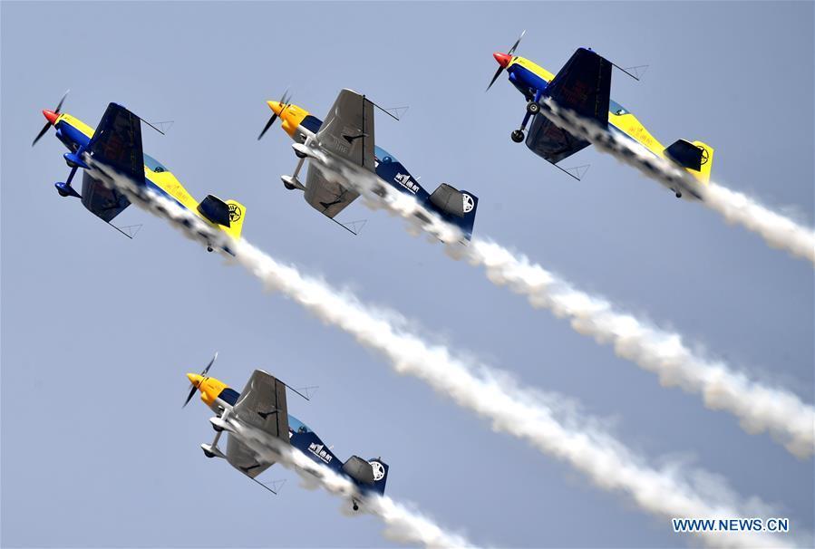 Enthusiasts in air sports give an aerobatic show during the opening of the 11th Air Sports Culture and Tourism Festival in Anyang, central China\'s Henan Province, June 3, 2019. The event kicked off Monday in the city of Anyang, attracting air sports fans from home and abroad. (Xinhua/Li Jianan)