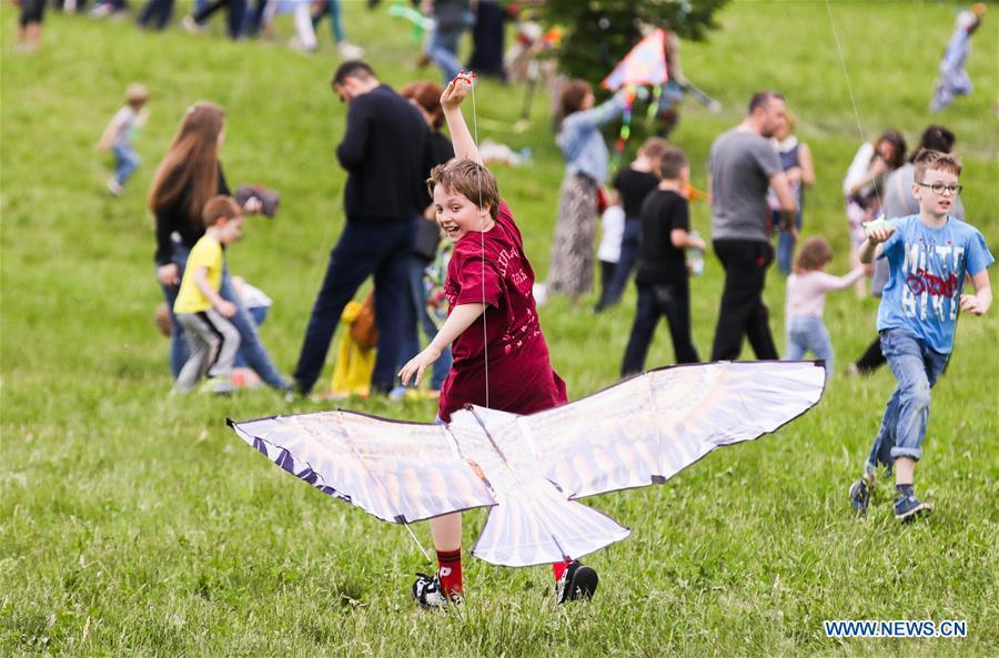 A boy flies a kite during the Motley Sky festival in Moscow, Russia, on May 26, 2019. The Motley Sky festival was held in Moscow from May 25 to 26. (Xinhua/Maxim Chernavsky)