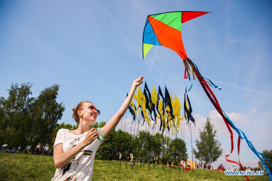 A woman flies a kite during the Motley Sky festival in Moscow, Russia, on May 26, 2019. The Motley Sky festival was held in Moscow from May 25 to 26. (Xinhua/Maxim Chernavsky)