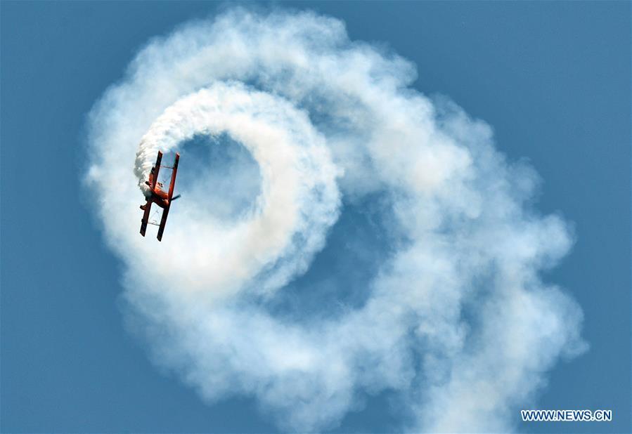 An enthusiast in air sports gives an aerobatic show during the opening of the 11th Air Sports Culture and Tourism Festival in Anyang, central China\'s Henan Province, June 3, 2019. The event kicked off Monday in the city of Anyang, attracting air sports fans from home and abroad. (Xinhua/Li Jianan)