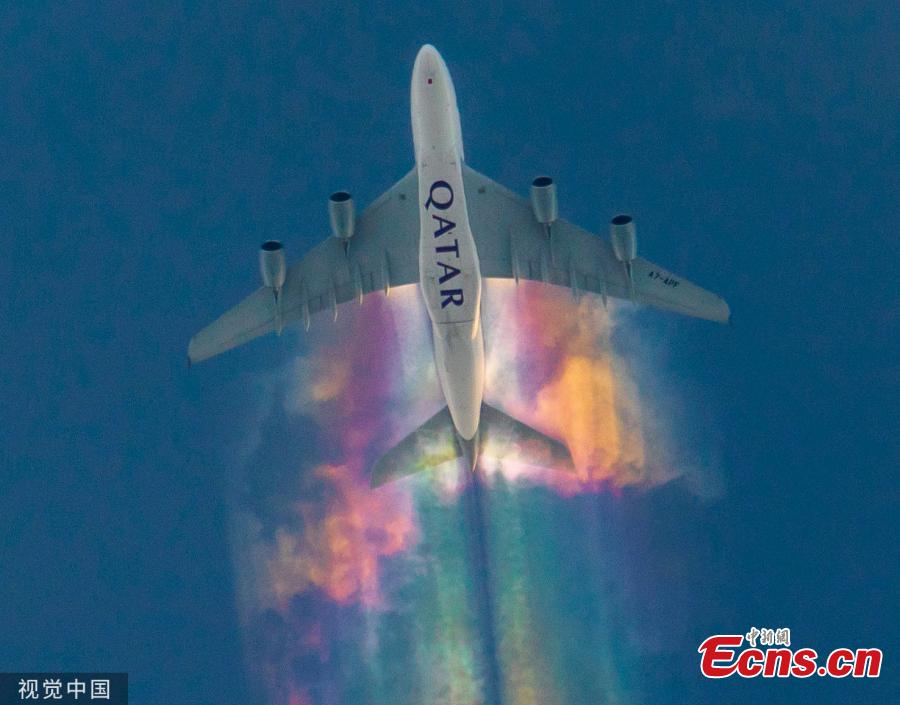 A Qatar Airways plane was caught brightening up the skies with a spectacular rainbow trail from its wings. The aircraft was spotted emitting the incredible multi-coloured clouds, also known as a rainbow contrail, as it flew over Bamberg, Germany. (Photo/VCG)