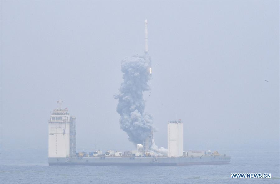 A Long March-11 solid propellant carrier rocket is launched from a mobile launch platform in the Yellow Sea off east China\'s Shangdong Province, June 5, 2019. China successfully launched a rocket from a mobile launch platform in the Yellow Sea off Shandong Province on Wednesday, sending two technology experiment satellites and five commercial satellites into space. A Long March-11 solid propellant carrier rocket blasted off at 12:06 p.m. from the mobile platform. It is China\'s first space launch from a sea-based platform and the 306th mission of the Long March carrier rocket series. (Xinhua/Zhu Zheng)
