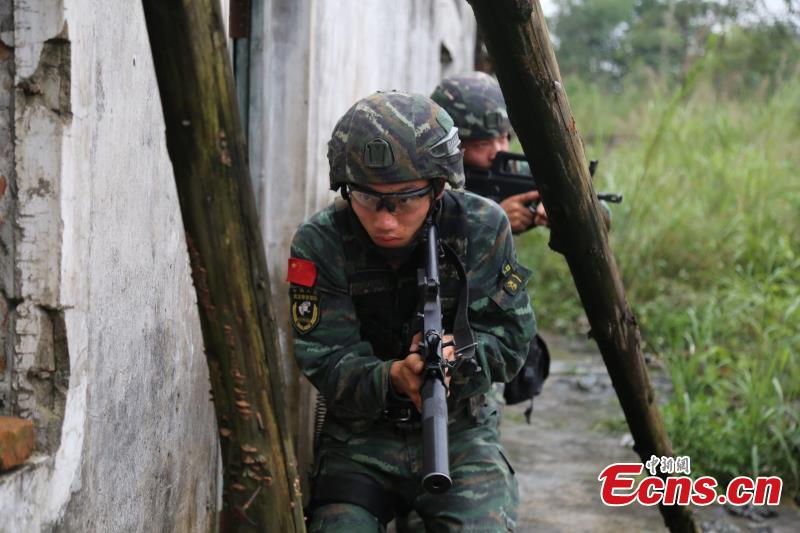 Armed police from the Snow Leopard Commando Unit undergoing intensive training in a hilly area under the blazing sun interrupted by a rainstorm. The training to last a week includes programs challenging the body and mind such as rescue missions and disposal of explosive ordnance. The Snow Leopard Commando Unit created in 2002 is mainly tasked with urban anti-terrorism missions and has safeguarded dozens of major events such as the Beijing Olympic Games, Xinhua reported. (Photo: China News Service/Li Jun)