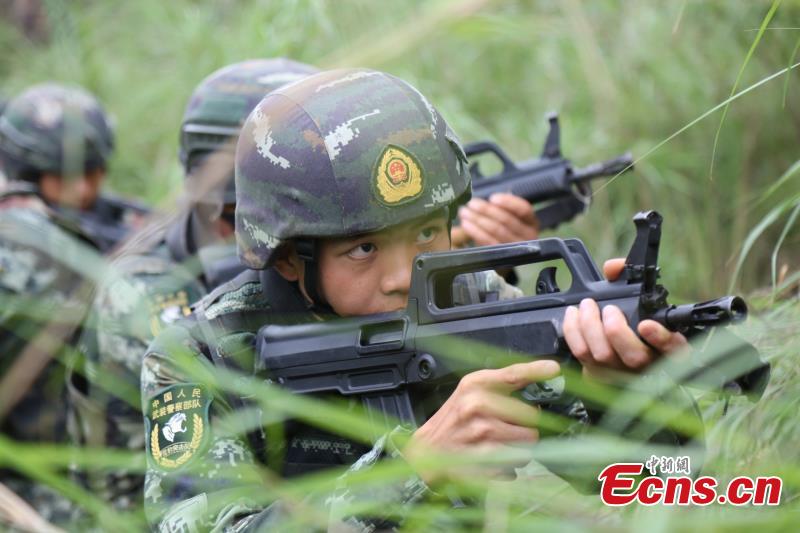 Armed police from the Snow Leopard Commando Unit undergoing intensive training in a hilly area under the blazing sun interrupted by a rainstorm. The training to last a week includes programs challenging the body and mind such as rescue missions and disposal of explosive ordnance. The Snow Leopard Commando Unit created in 2002 is mainly tasked with urban anti-terrorism missions and has safeguarded dozens of major events such as the Beijing Olympic Games, Xinhua reported. (Photo: China News Service/Li Jun)
