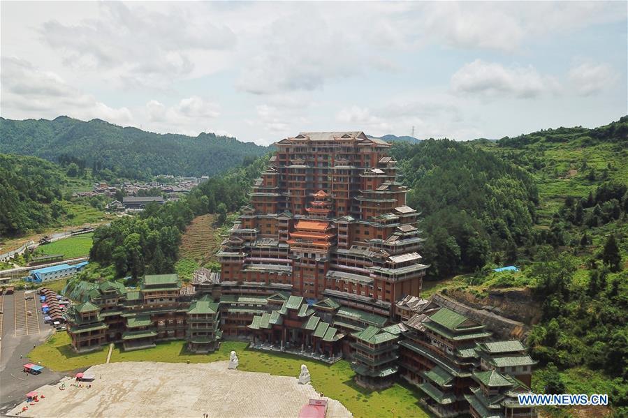 Aerial photo taken on June 7, 2019 shows a wooden building of Shui ethnic group in Yingshan Town of Dushan County, southwest China\'s Guizhou Province. The 24-story, 99.9-meter-high traditional Shui-style wooden building in Dushan is of \