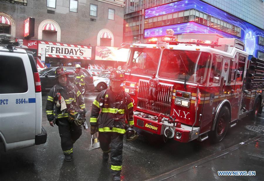 Fire fighters walk on the street near the building where a helicopter crashed in Manhattan, New York, the United States, June 10, 2019. One person was killed after a helicopter crashed onto the roof of a skyscraper in Midtown Manhattan of New York City Monday afternoon, according to media reports. (Xinhua/Wang Ying)